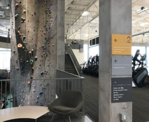 CU Boulder Rec Center climbing wall direction signs stacked