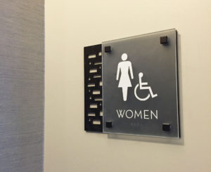 Ovation Apartments restroom sign