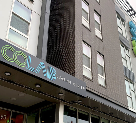 Colab Apartments exterior leasing center sign