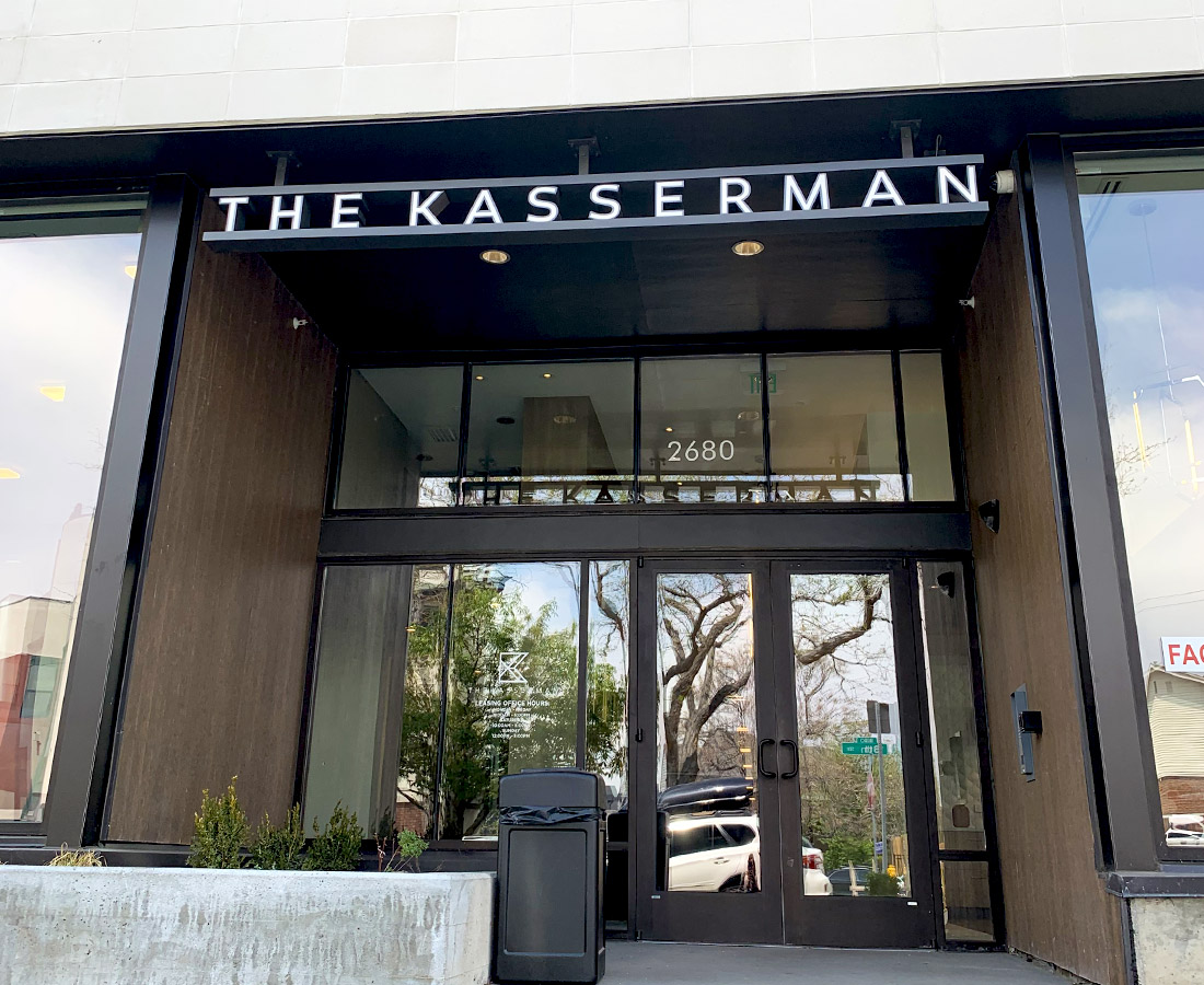 The Kasserman exterior sign letterset above entrance, close up.