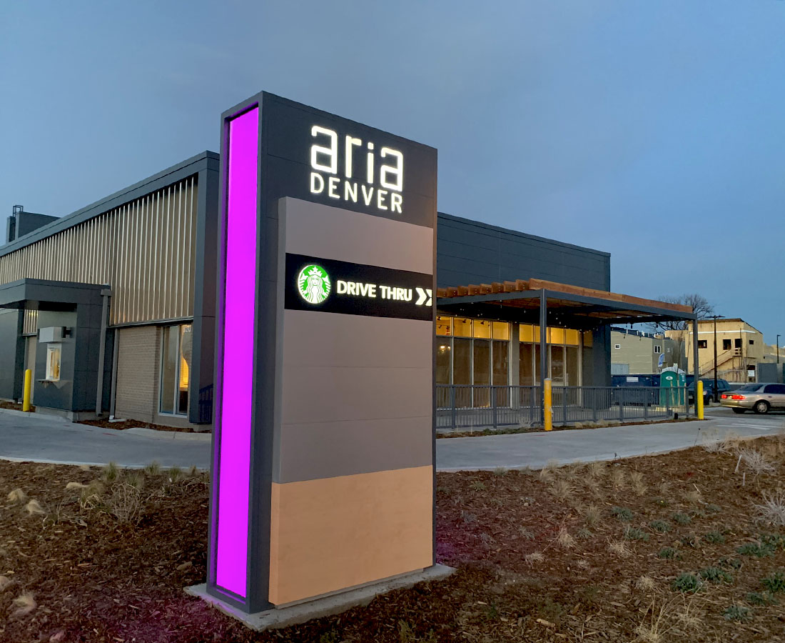 Aria Denver illuminated color changing monument sign, Starbucks tenant panel