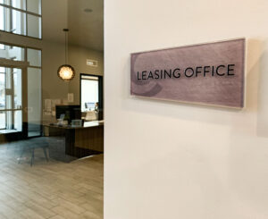 Cycle Apartments glass ada leasing office sign
