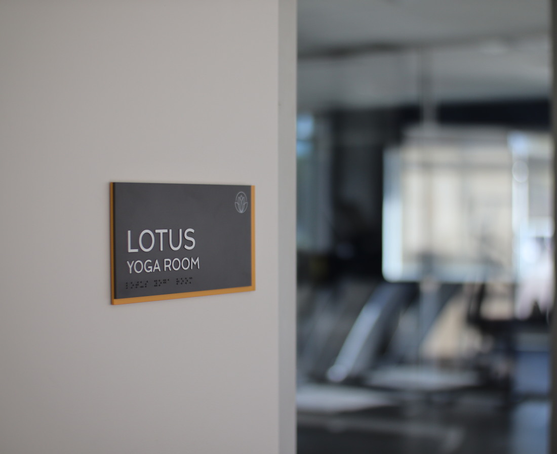 ADA sign for the Lotus Yoga Room, an essential feature for accessibility.